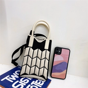 Mini knitted crossbody phone bag with black wave patterns and cream handle