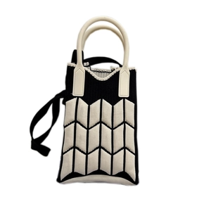 Mini knit crossbody phone bag with black and white wave patterns and white handles