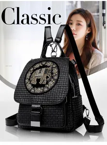 Close-up of black woven texture backpack with sparkling rhinestone elephant decoration