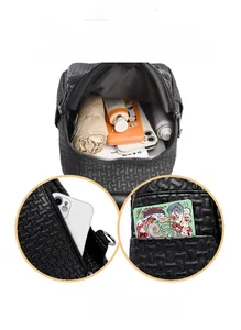 Detailed interior storage showing capacity for umbrella and phone in a woven backpack