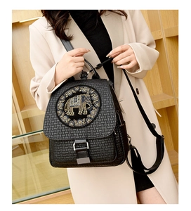 Detailed view of black woven texture leather backpack with rhinestone elephant motif