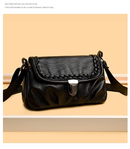 Détail du sac à bandoulière vintage noir avec bords tressés et boucle en métal argenté