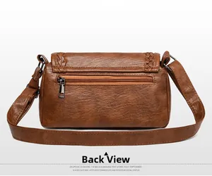 Vue arrière du sac bandoulière vintage marron avec poche zippée et bords tressés