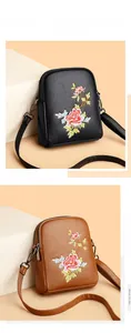 Detailed close-up of floral embroidery on dual-zipper crossbody cell phone bags