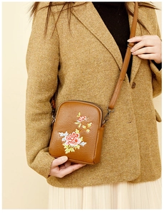 Close-up of floral embroidery on a vintage brown PU leather crossbody cell phone bag