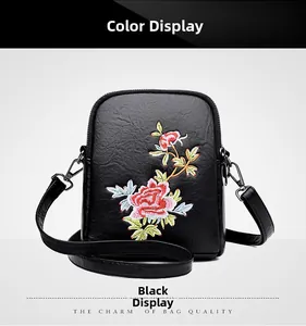 Close-up of elegant floral embroidery and textured black PU leather on the crossbody bag