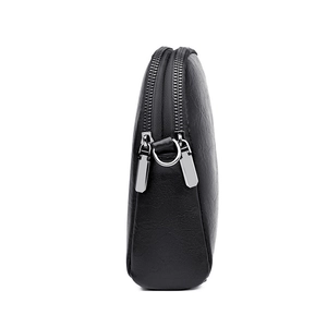 Chic black double-zipper crossbody bag with intricate embroidery and silver hardware