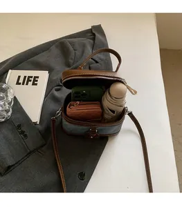 Detail of vintage blue denim bag interior showing space for phone and capsule umbrella