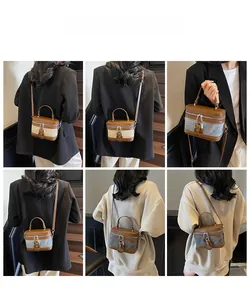 Model display of vintage box-style crossbody bag with leather handles and canvas texture