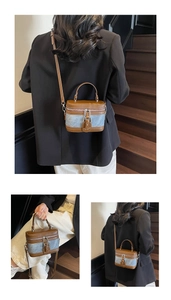 Detail of vintage patchwork cylinder bag featuring blue denim and brown leather accents