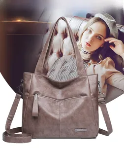 Macro detail of retro brown leather tote with decorative zipper and metal logo