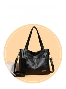 Close-up of black litchi pattern tote bag with golden metal logo and dual handles