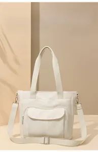 Front view of beige nylon tote bag with multiple pockets and adjustable shoulder strap