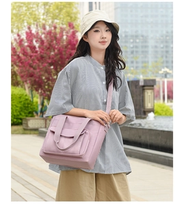 Detail of purple nylon tote bag with large front pocket and adjustable strap