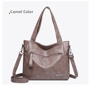 Detailed macro of camel tote bag with BaiLeTao logo plaque and leather texture