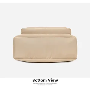 Flat bottom view of the beige nylon shoulder bag showing durable stitching and texture