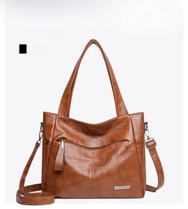 Detailed front view of brown tote bag with retro lychee texture and metallic logo