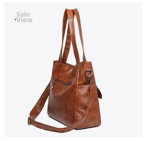 Side view of large brown faux leather tote bag with shoulder strap and side pocket