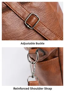 Detail of adjustable metal buckle and reinforced stitching on brown tote shoulder strap