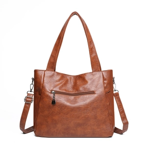 Vintage brown leather tote bag with dual handles and adjustable shoulder strap for women