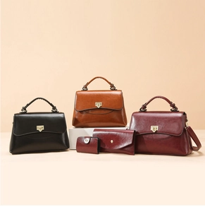 Detailed set of vintage leather handbags featuring gold triangle twist locks and wallets