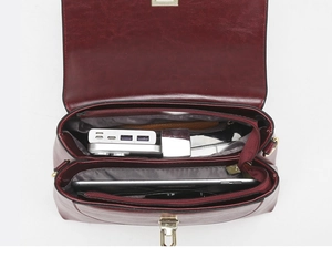 Detail view showing organized interior compartments of the burgundy faux leather handbag