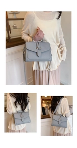 Detail view of grey-blue square handbag showing荔枝 texture and metallic buckle closure