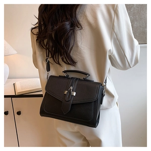 Litchi texture black square handbag styled with a white blazer for a chic look