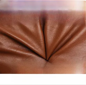 Detailed macro view of soft brown leather texture and zipper on this women's shoulder bag