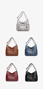 Multiple colors of women's multi-pocket crossbody bags showing the pebbled leather texture