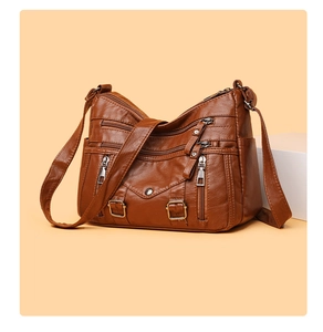 Detail view of brown multi-pocket crossbody bag with vintage PU leather and metal zippers