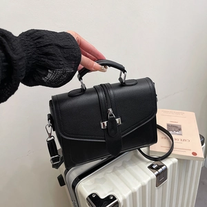 Fashionable black lychee grain leather square handbag with silver zipper detail and strap