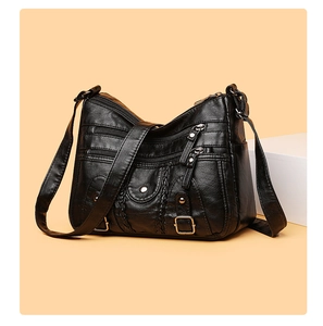 Détails du sac bandoulière en cuir lavé noir avec plusieurs poches zippées et des rivets