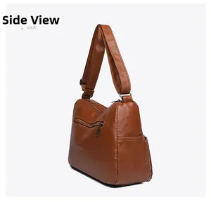 Rear side view of brown faux leather shoulder bag with functional zipper pockets