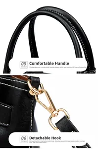 Close-up of reinforced handles and gold metal clips on black pebbled leather tote bag