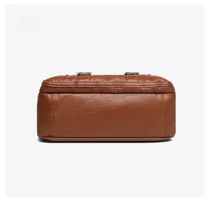 Detailed bottom view of brown litchi pattern leather bag with reinforced stitching