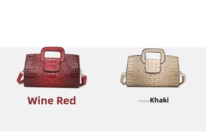 Detailansicht von weinroten und khakifarbenen Kroko-Handtaschen mit quadratischen Griffen