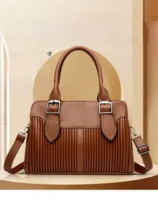 Detail of brown litchi pattern leather bag showing pleated design and silver buckle