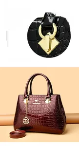 Close-up of golden kangaroo charm and premium crocodile texture on deep red leather bag