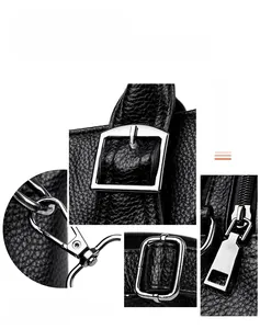 Detail of black lychee grain leather handbag with silver hardware and tassel charm