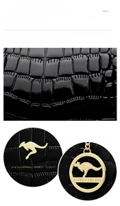 Close-up of black crocodile pattern patent leather with golden kangaroo brand charms