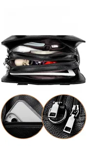 Three-layer black pebble leather handbag showing spacious interior and silver zippers