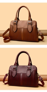 Detail of lychee pattern leather handbags with vertical pleats and silver hardware