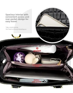 Internal view of crocodile pattern handbag with multiple compartments and spacious storage
