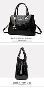 Close-up of black crocodile pattern patent leather handbag with gold kangaroo charm
