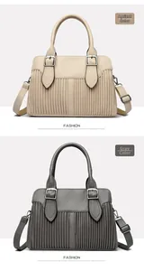 Close-up of pleated leather texture and metal buckle detail on apricot and grey bags