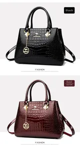 Close-up of glossy crocodile pattern patent leather handbag with gold kangaroo logo