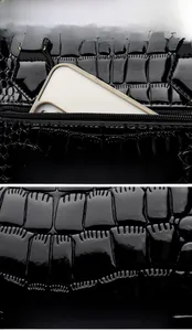 Detail view of black crocodile pattern faux leather with functional back pocket for storage