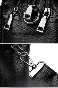 Close-up of black lychee grain leather bag with gunmetal zippers and detachable hooks