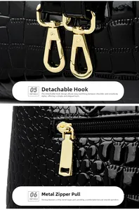 Detail of glossy black crocodile embossed leather with gold hooks and smooth zipper hardware
